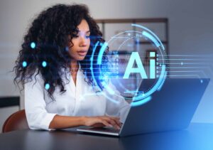 Young African American business women working on computer with an "AI" holographic overlayed, balancing the human touch with AI in learning experiences