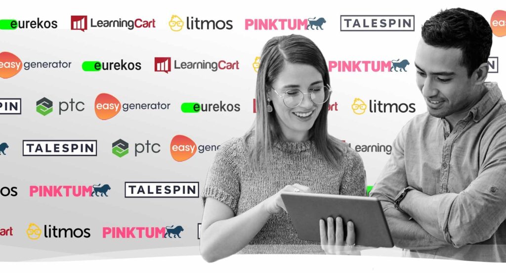 A young Caucasian women, and a hispanic male looking at a tablet with partner logo's step and repeated behind them.